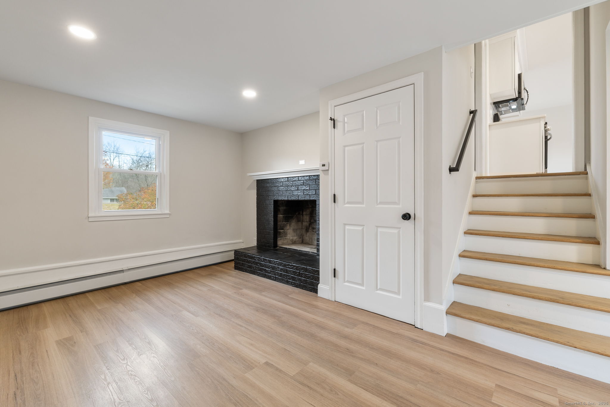 410 South Stone Street Suffield, CT 06093 - Photo 11 of 23 a view of an empty room with a fireplace and a window