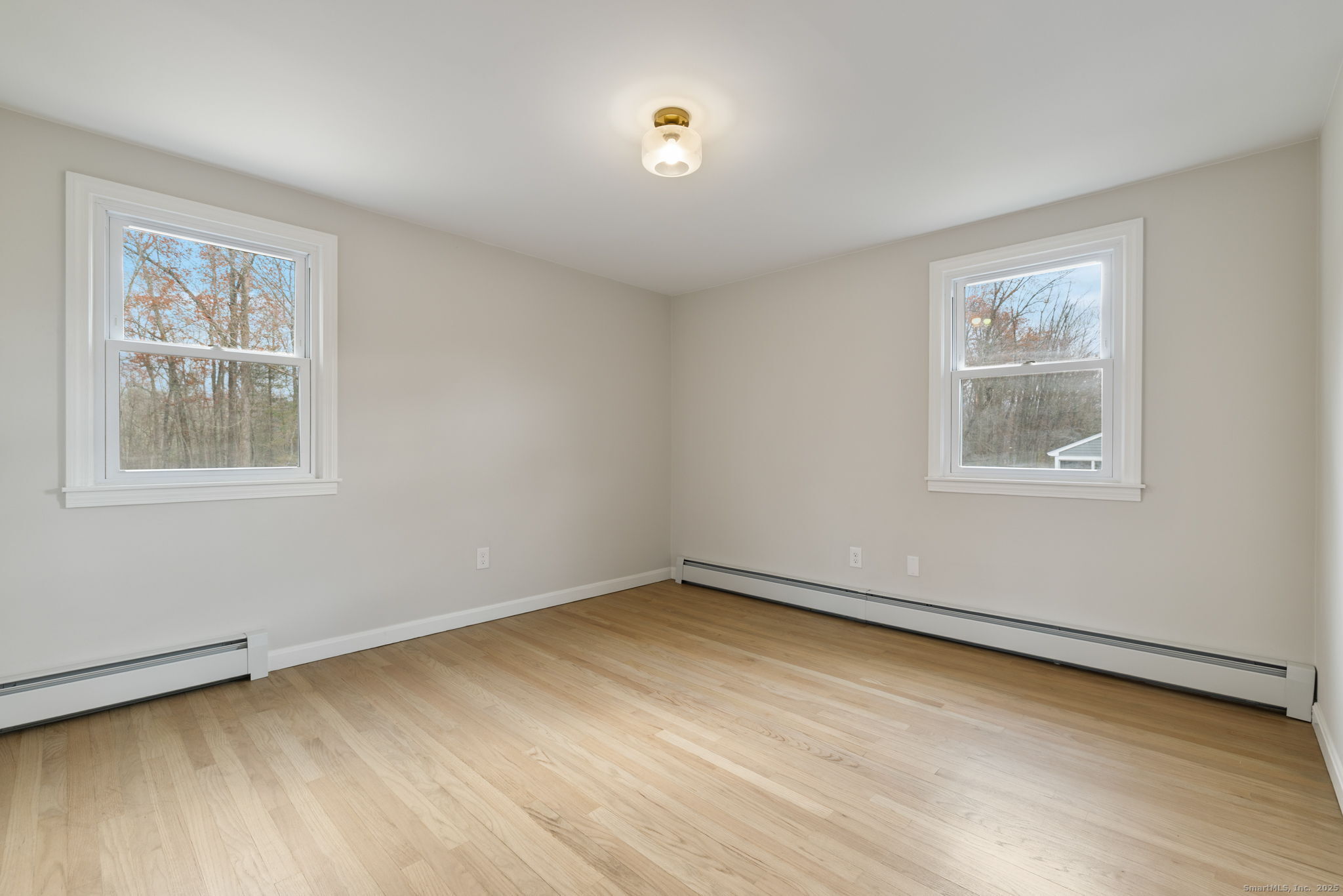 410 South Stone Street Suffield, CT 06093 - Photo 13 of 23 a view of an empty room with a window and wooden floor