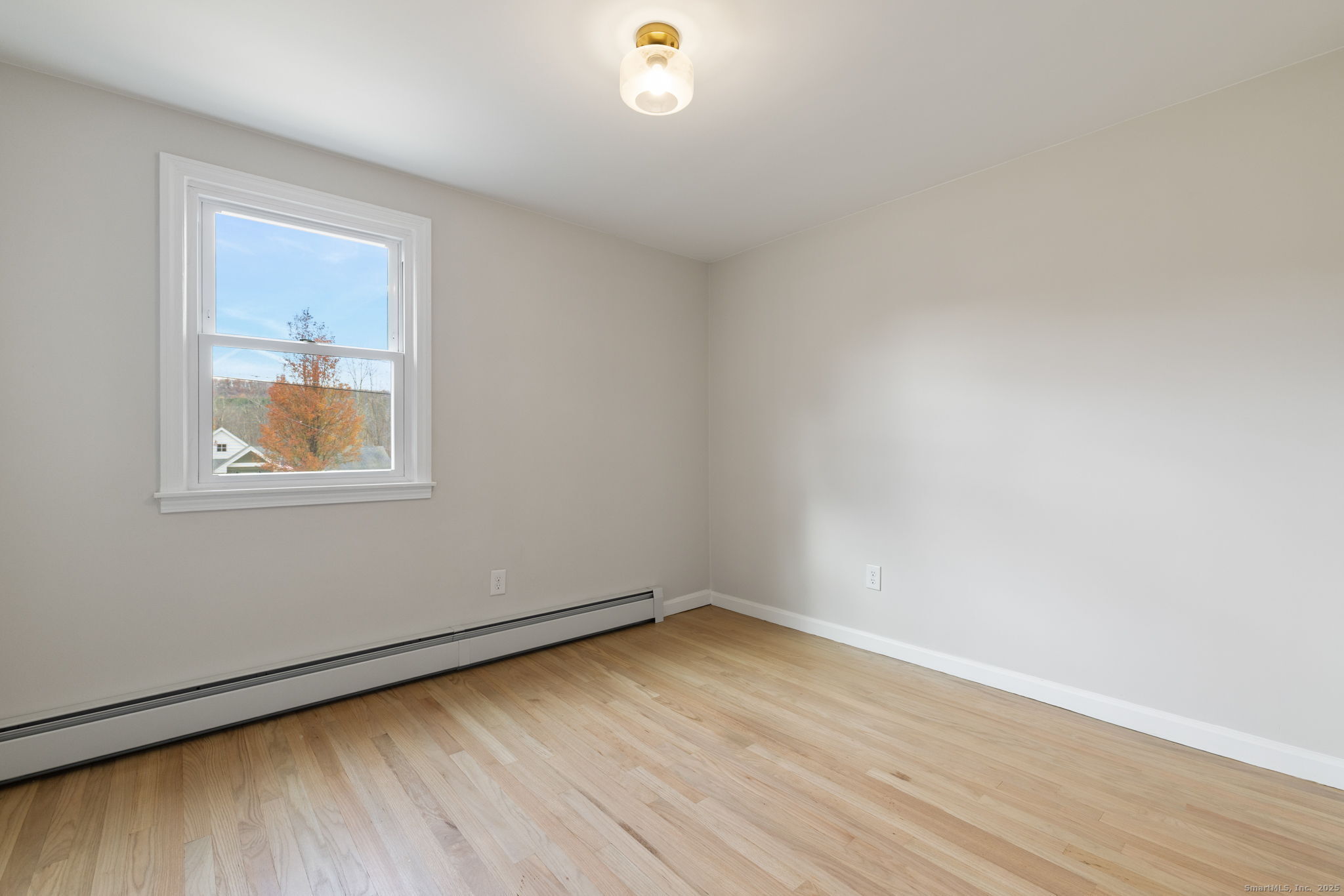 410 South Stone Street Suffield, CT 06093 - Photo 16 of 23 wooden floor in an empty room with a window