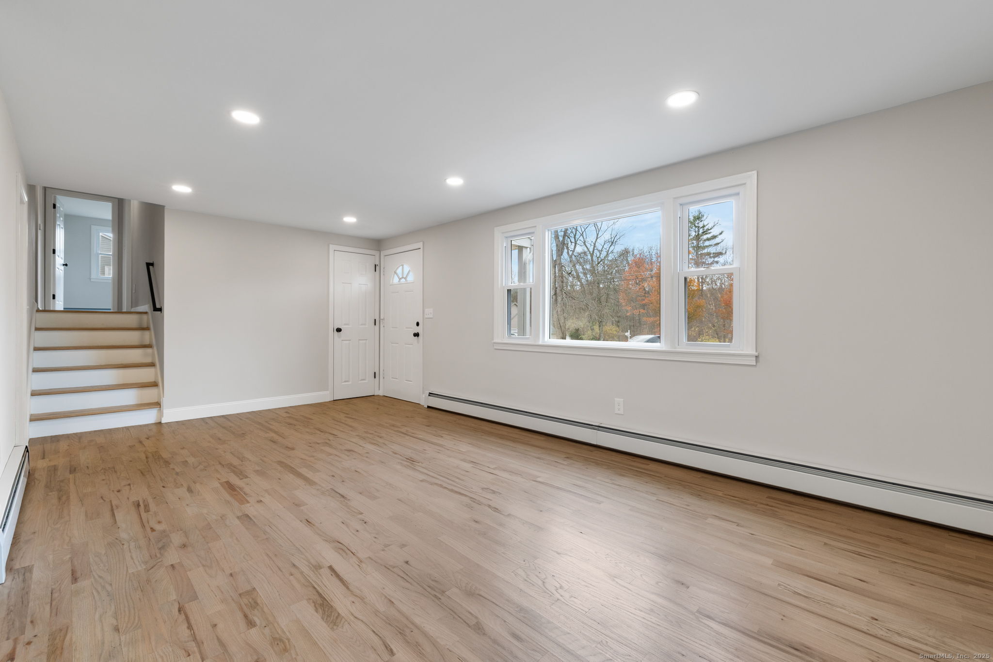 410 South Stone Street Suffield, CT 06093 - Photo 3 of 23 a view of an empty room with wooden floor and a window