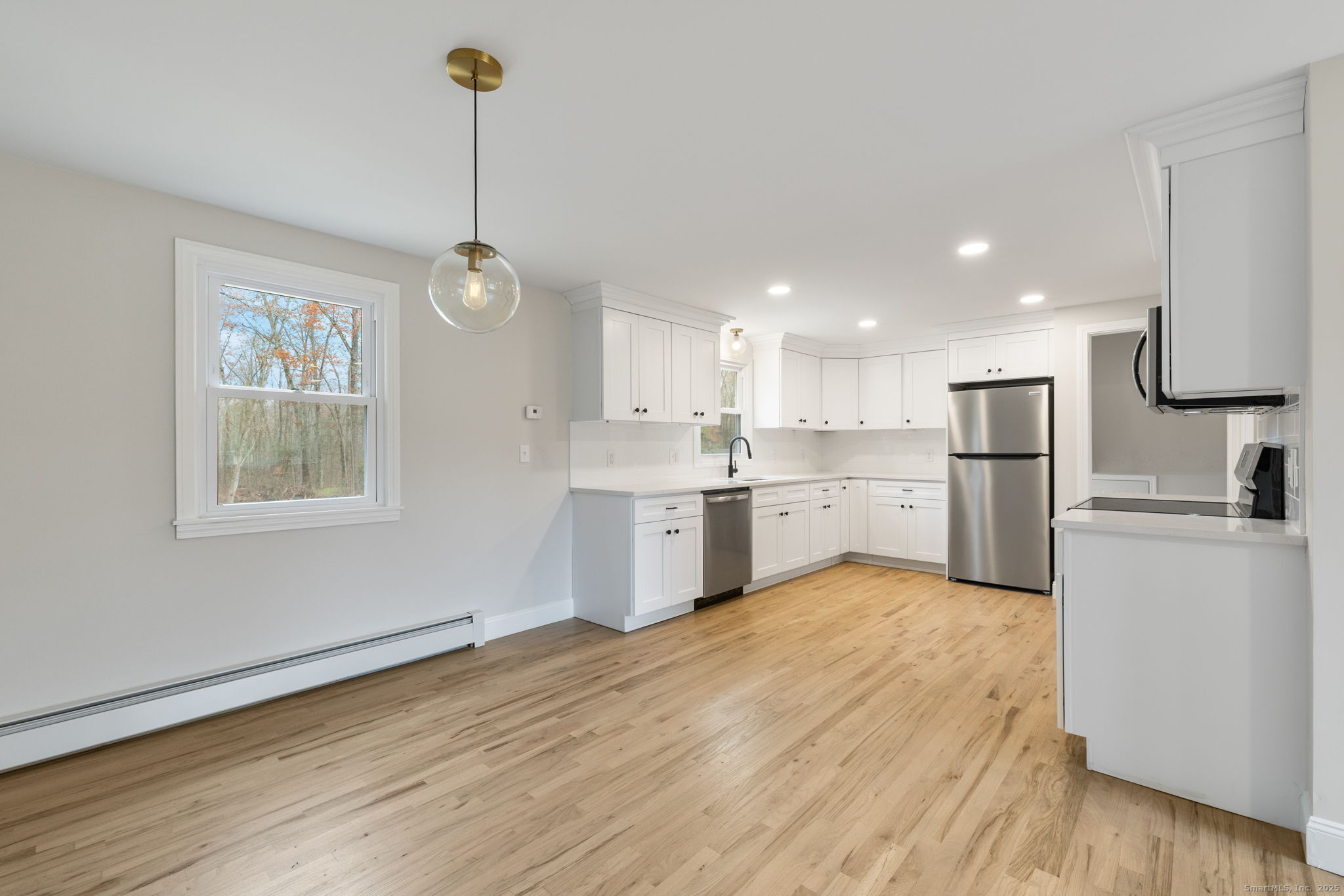 410 South Stone Street Suffield, CT 06093 - Photo 5 of 23 a kitchen with stainless steel appliances granite countertop a refrigerator a sink dishwasher a stove and white countertops with wooden floor