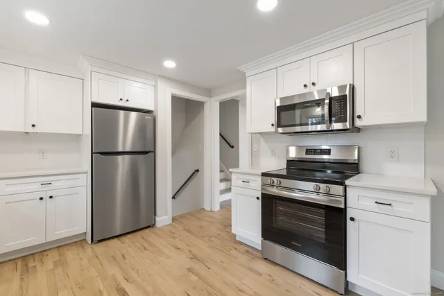 a kitchen with a refrigerator stove and microwave