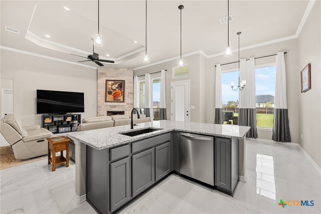 223 Sand Flat Lane Temple, TX 76502 - Photo 12 of 33 a kitchen with a sink center island and stainless steel appliances