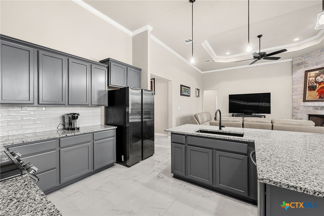 223 Sand Flat Lane Temple, TX 76502 - Photo 14 of 33 a kitchen with stainless steel appliances granite countertop a sink a stove and a refrigerator