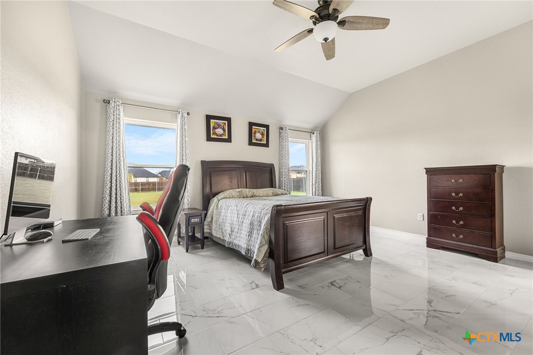 223 Sand Flat Lane Temple, TX 76502 - Photo 15 of 33 a bedroom with a bed and a chandelier