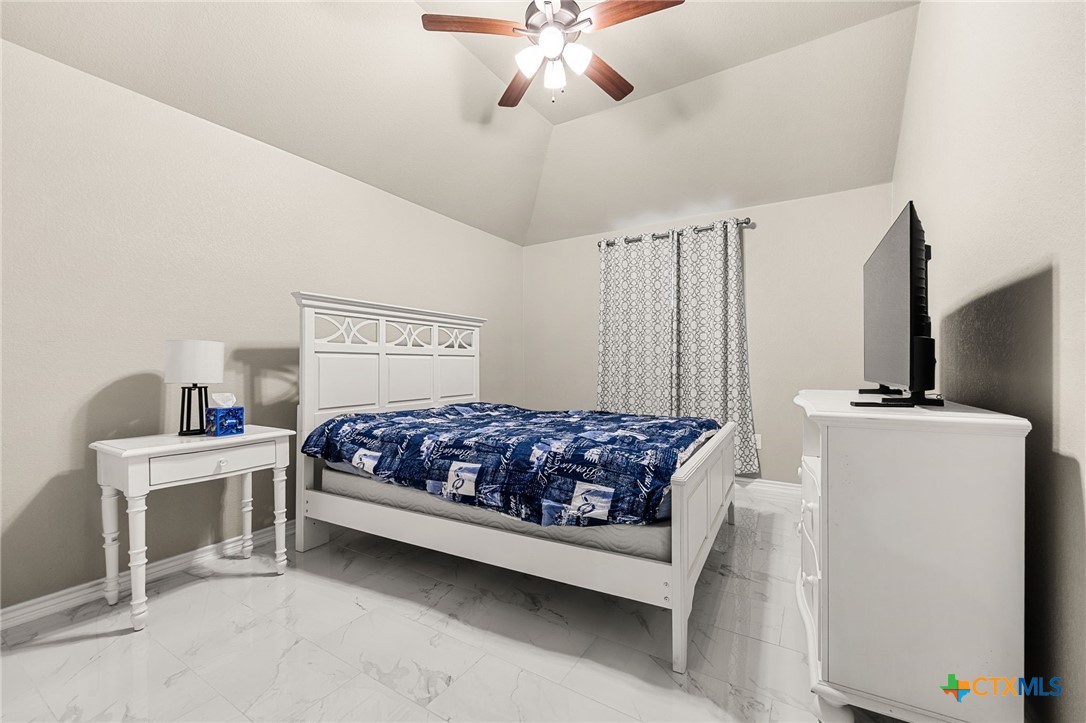 223 Sand Flat Lane Temple, TX 76502 - Photo 21 of 33 a bedroom with a bed and a chandelier