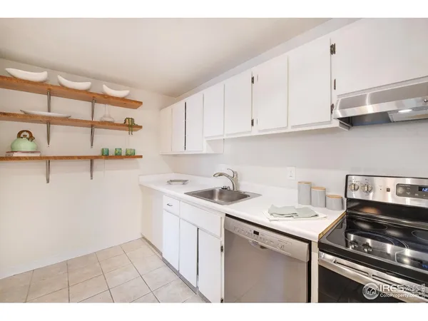 a kitchen with a sink cabinets and appliances