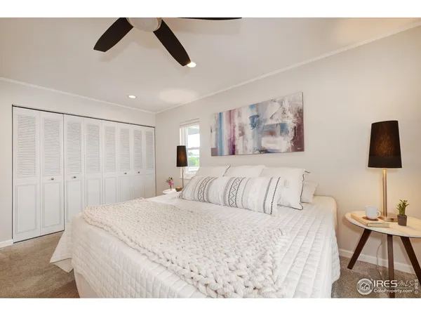 a bedroom with a bed and a painting on the wall