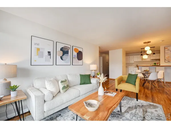 a living room with furniture and painting on the wall