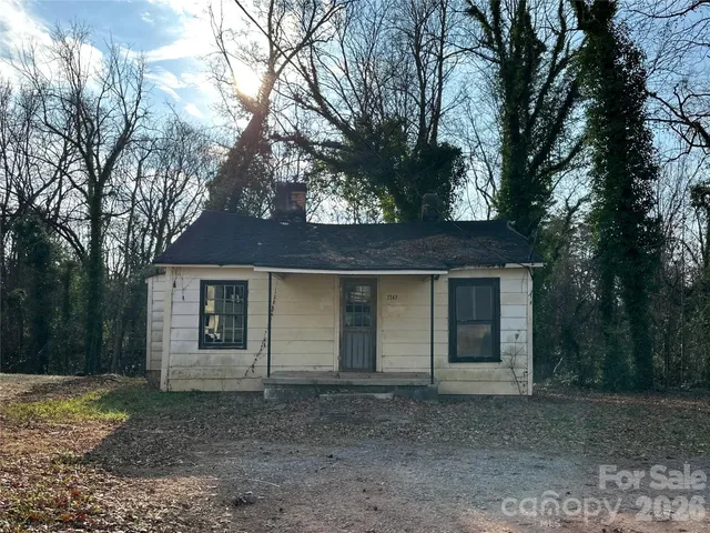 a house that has a tree in front of it