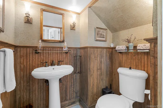 a bathroom with a sink mirror toilet and a shower