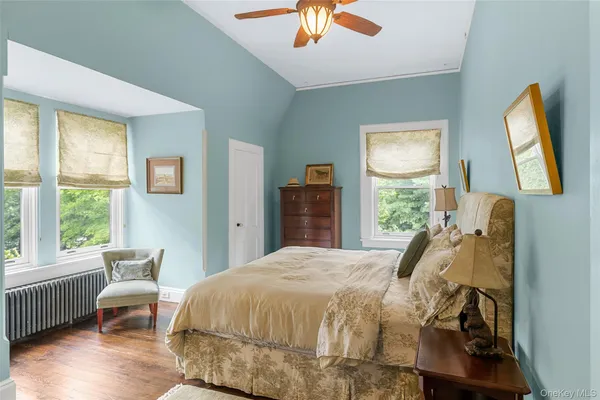 a bed sitting in a bedroom next to a window