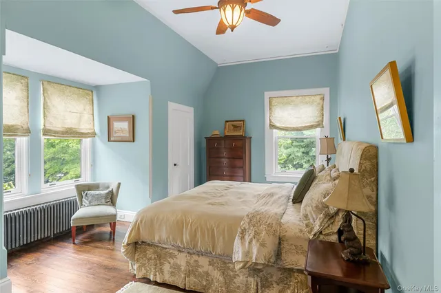a bed sitting in a bedroom next to a window