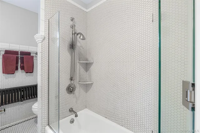 a bathroom with a bathtub and shower