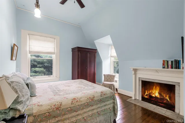 a bedroom with a bed and a fireplace