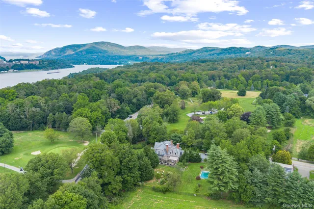 a view of a lush green hillside and houses