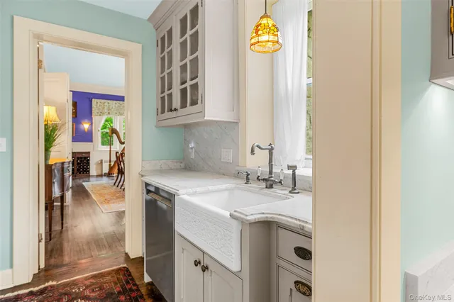 a en suite bathroom with a granite countertop sink and a mirror