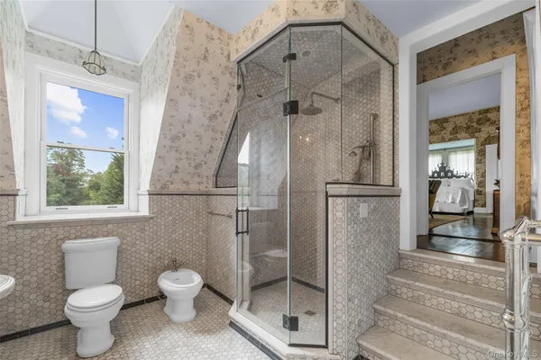 a bathroom with a toilet and a shower