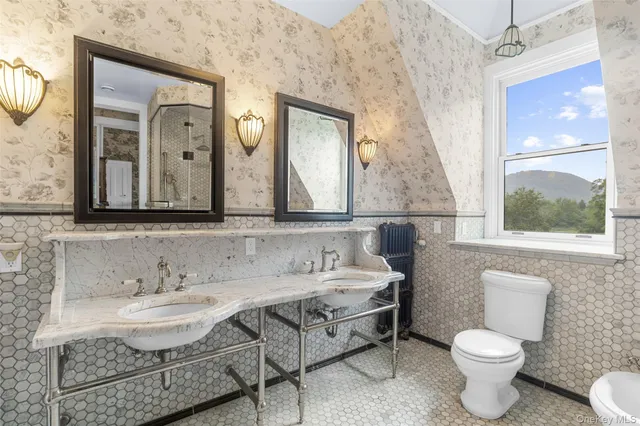 a bathroom with a granite countertop toilet a sink and a mirror