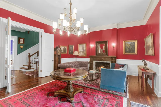 a view of a dining room with furniture and chandelier