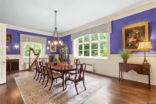 a dining room with furniture a chandelier and wooden floor