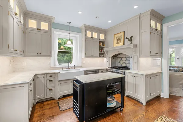 a kitchen with a sink stove and cabinets
