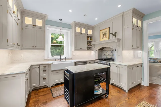 a kitchen with a sink stove and cabinets