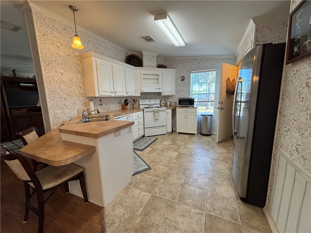 6171 98th Road Sebastian, FL 32958 - Photo 6 of 14 a kitchen with a sink appliances and cabinets