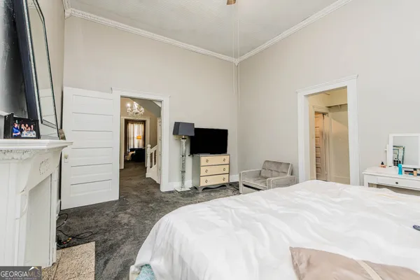 a bedroom with a bed and a flat screen tv