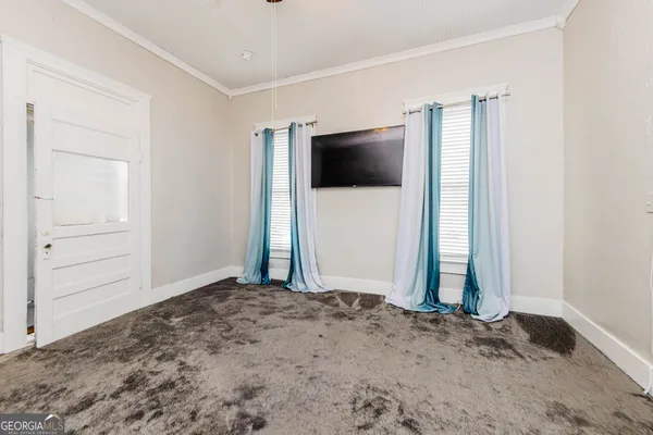 a bathroom with a toilet a sink and a window