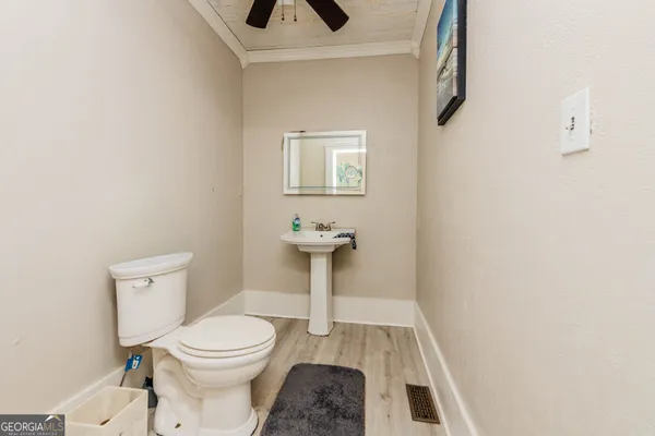 a view of a big room with wooden floor and brick walls
