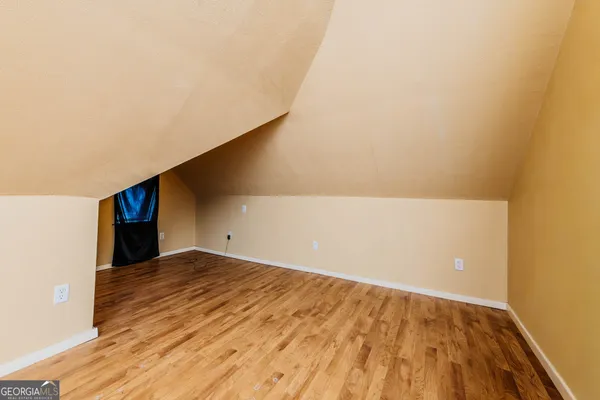 a bathroom with a sink mirror and bathtub