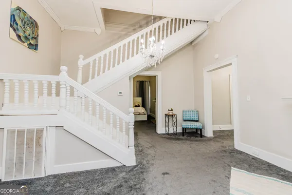 a kitchen with granite countertop white cabinets and white appliances