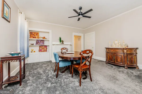 a dining room with furniture and window