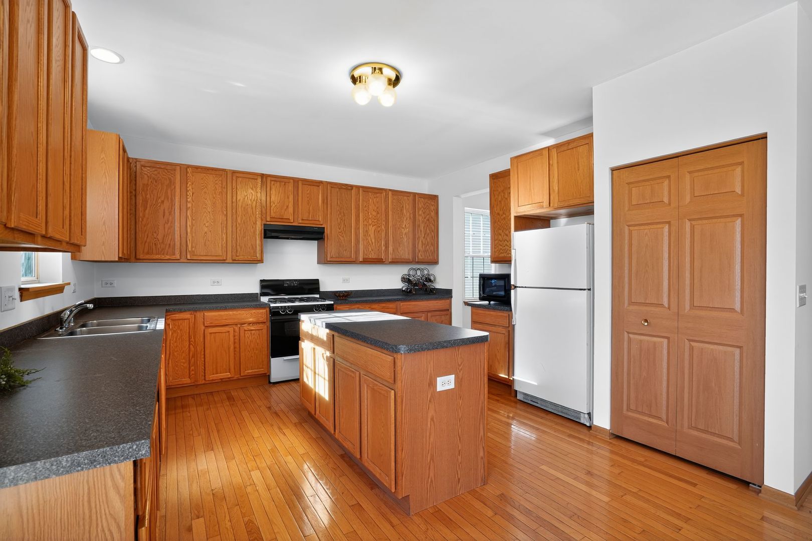 2722 Moraine Valley Road Wauconda, IL 60084 - Photo 13 of 42 a kitchen with stainless steel appliances granite countertop a refrigerator a stove top oven a sink dishwasher and a refrigerator with wooden floor