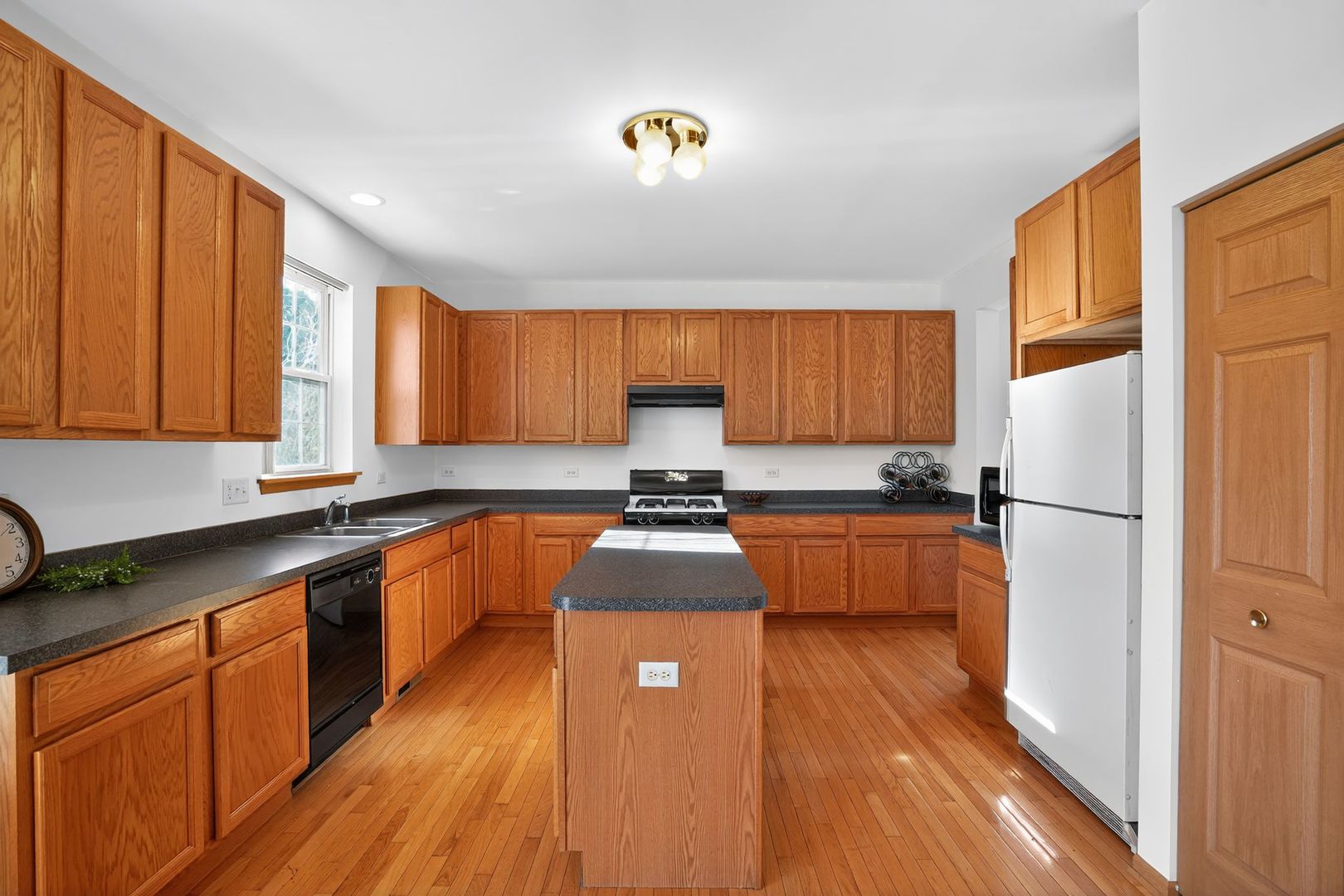 2722 Moraine Valley Road Wauconda, IL 60084 - Photo 17 of 42 a kitchen with stainless steel appliances granite countertop a refrigerator a sink dishwasher a stove with wooden floor and cabinets