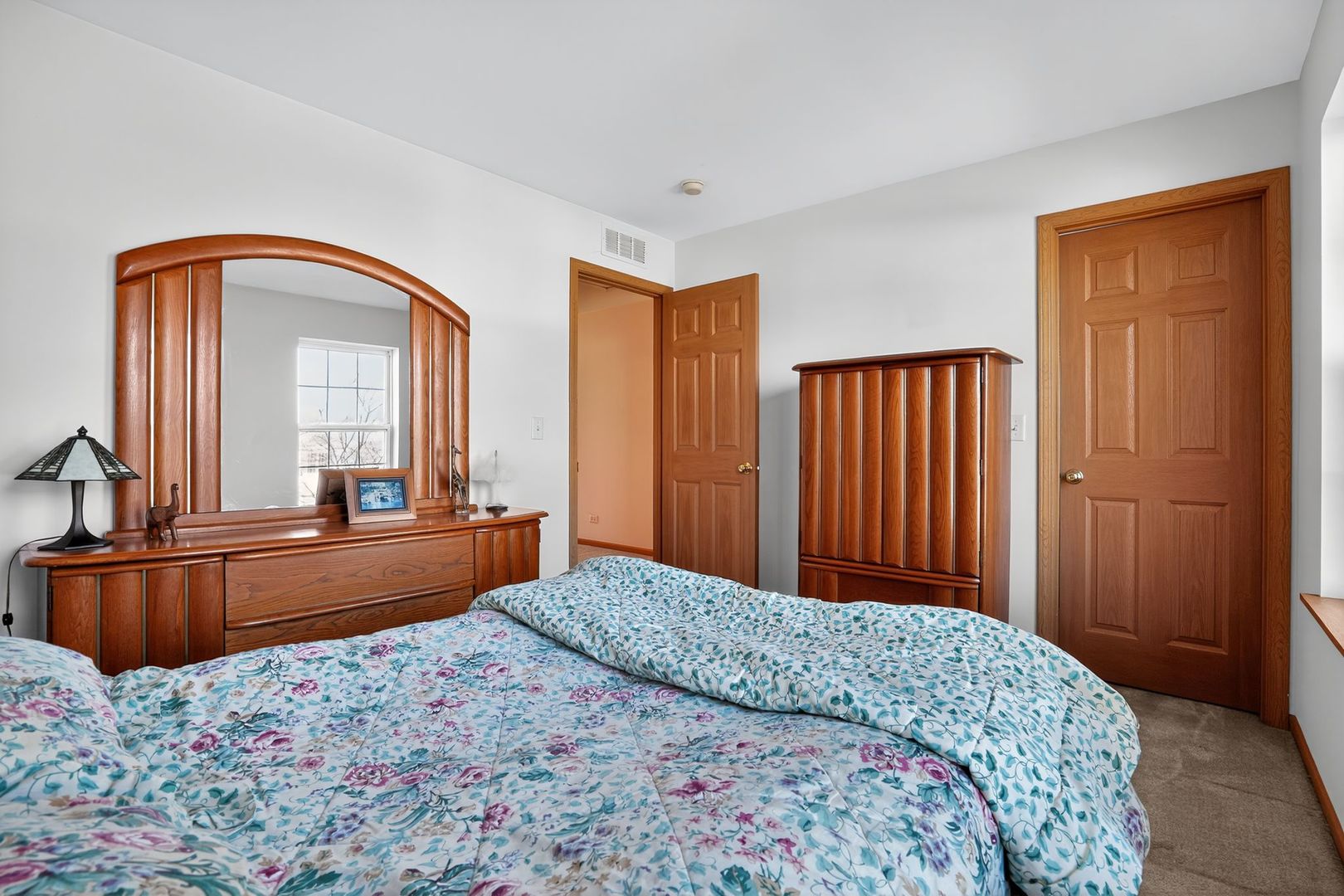 2722 Moraine Valley Road Wauconda, IL 60084 - Photo 34 of 42 a bedroom with a bed and a dresser with mirror