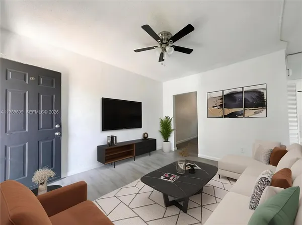 a living room with furniture and a flat screen tv
