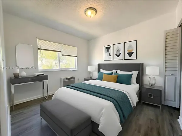 a bedroom with a bed and a window