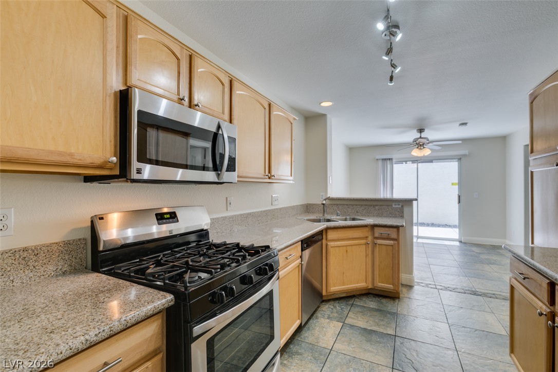 200 Luninborg Street Henderson, NV 89074 - Photo 8 of 40 A contemporary kitchen offers ample counter space and seamless flow into the adjacent living area.