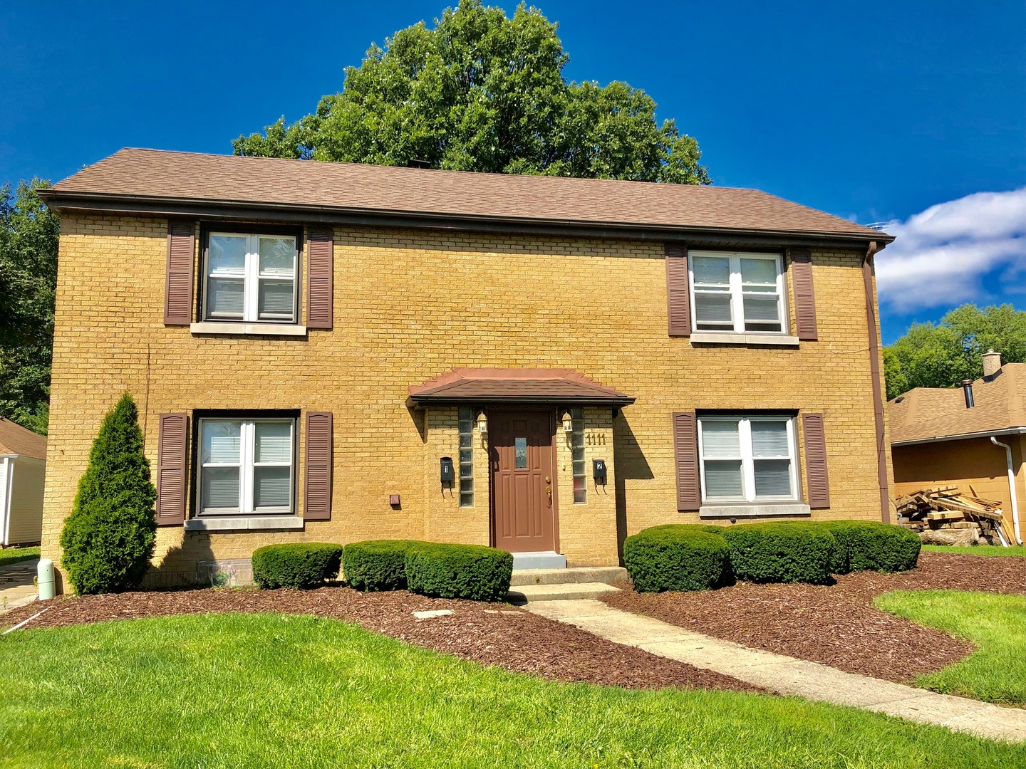 1111 Lincoln Street, Unit 2 Lockport, IL 60441 - Photo 13 of 13 a front view of a house with a yard