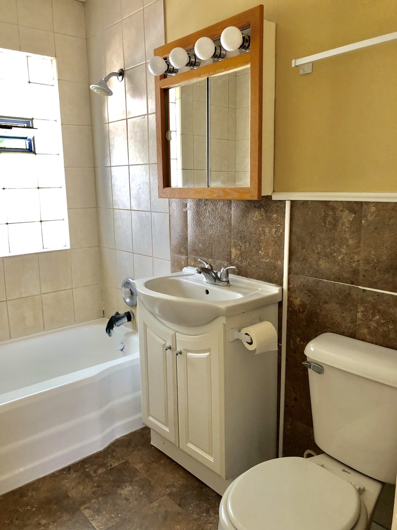 1111 Lincoln Street, Unit 2 Lockport, IL 60441 - Photo 7 of 13 a bathroom with a sink toilet and shower