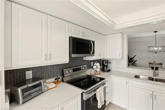 a kitchen with stainless steel appliances a refrigerator sink and cabinets