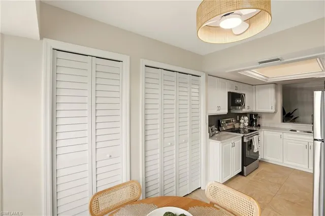 a kitchen with refrigerator and cabinets