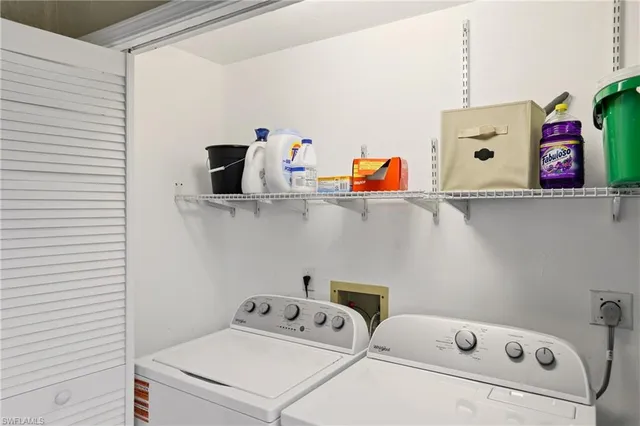 a view of a room with furniture and windows