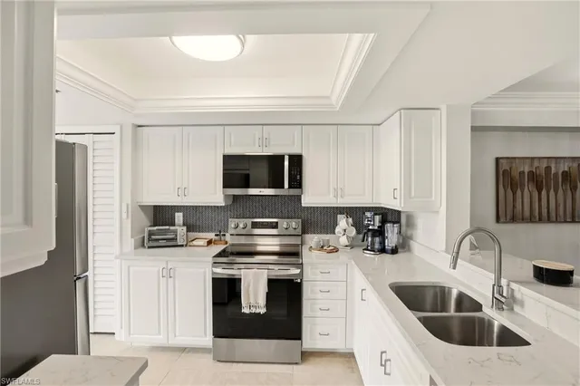 a kitchen with a sink stove and refrigerator