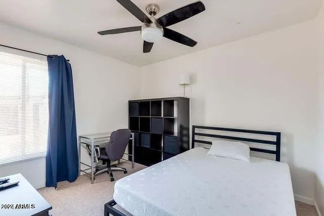 a bedroom with a bed and a desk