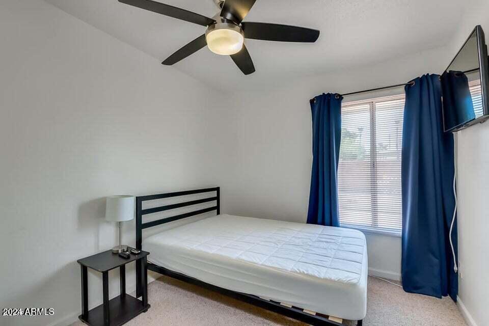 525 North May, Unit 10 Mesa, AZ 85201 - Photo 13 of 21 a bedroom with a bed and a window