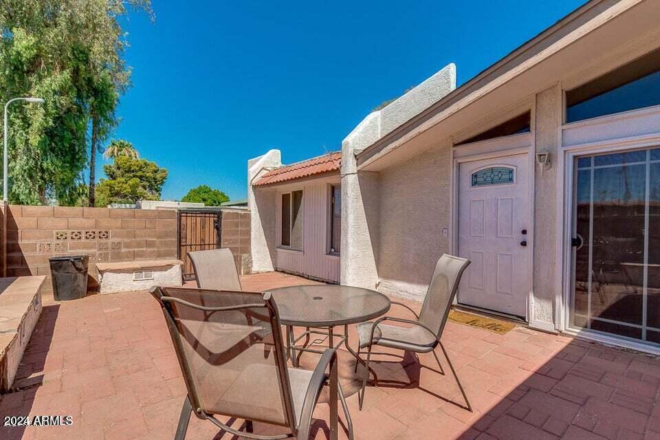 525 North May, Unit 10 Mesa, AZ 85201 - Photo 16 of 21 a patio with table and chairs and potted plants