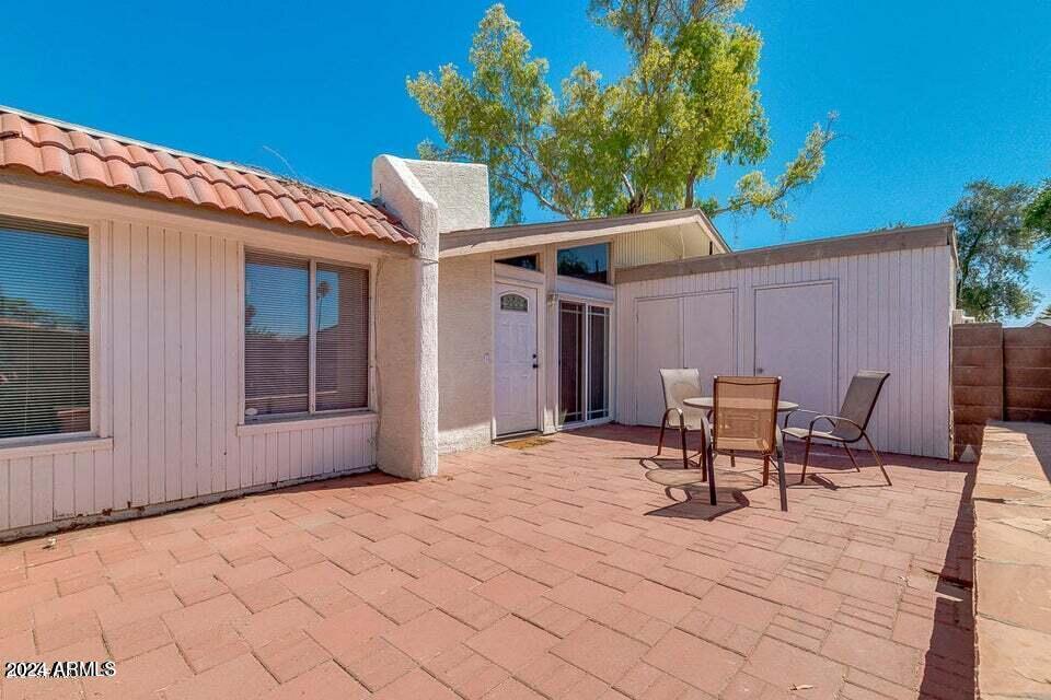 525 North May, Unit 10 Mesa, AZ 85201 - Photo 17 of 21 a backyard of a house with table and chairs